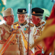 Sultan Muhammad V, left, chats with Malaysian Prime Minister Najib Razak, right, and Deputy Prime Minister Ahmad Zahid Hamidi, center, after his welcoming ceremony at the Parliament House in Kuala Lumpur, Malaysia, Tuesday, Dec. 13, 2016. Sultan Muhammad V of Kelantan will serve a five-year term as King of Malaysia from Tuesday. (AP Photo/Vincent Thian)